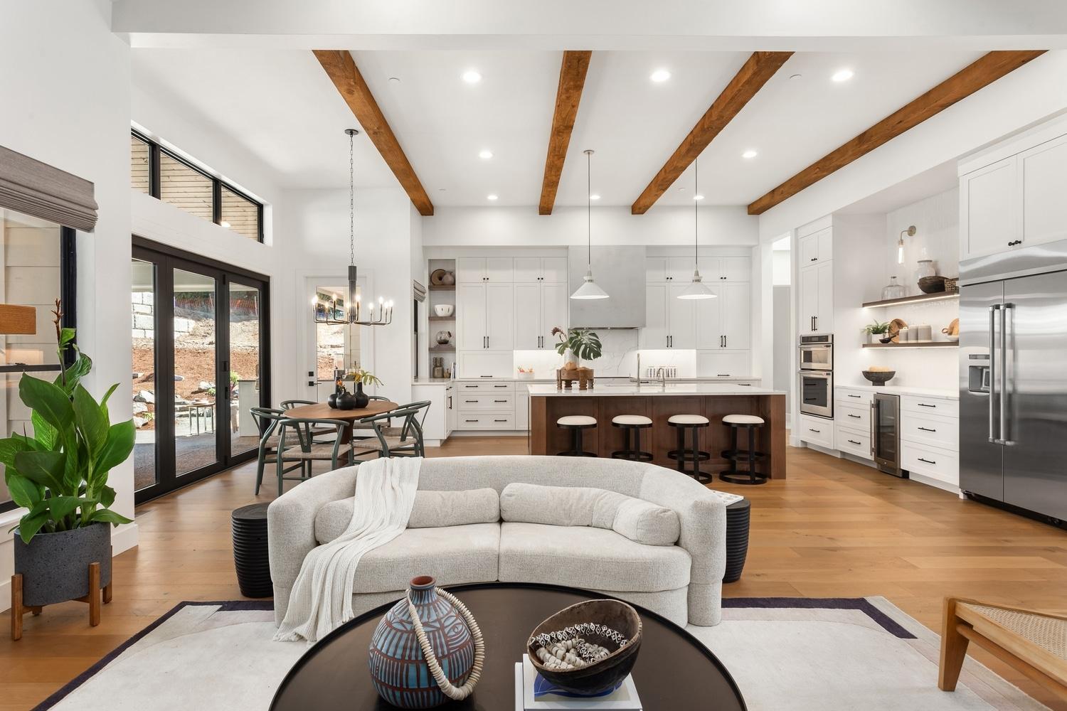 Bright and spacious open floor plan home featuring a seamless kitchen, dining, and living area with modern decor.