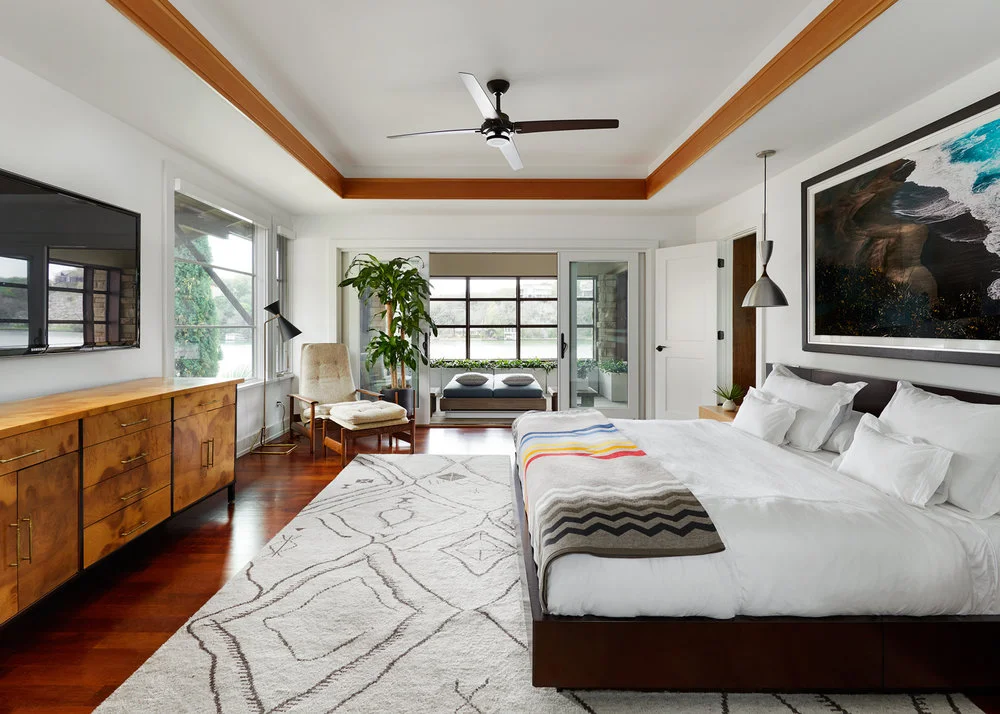 This sleek, contemporary bedroom is a perfect example of a home remodel in Austin, blending comfort and modern aesthetics with a stylish design.