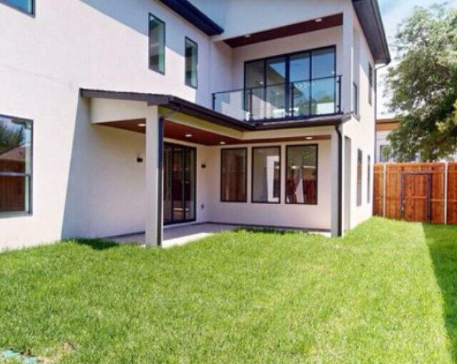 Rear view of villa with clean landscaping and new exterior paint