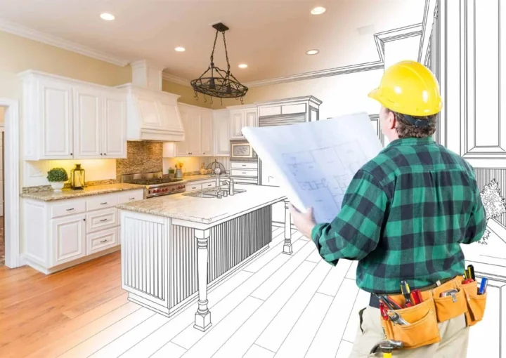 Austin remodeling contractors reviewing kitchen blueprints to create a fully customized cooking space with premium cabinetry and finishes.