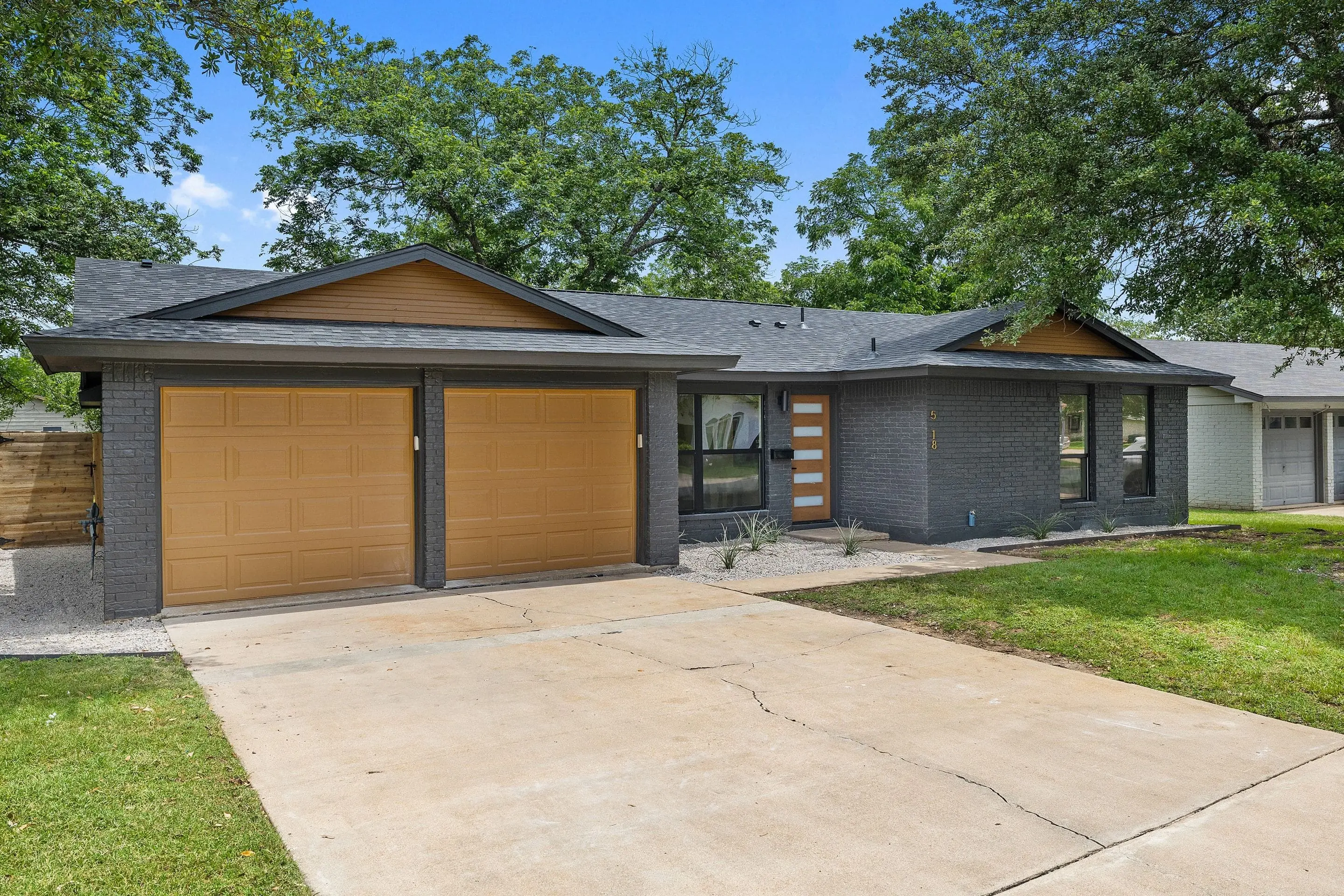 Modern gray home exterior with a two-car garage at The Fairmont remodeling project