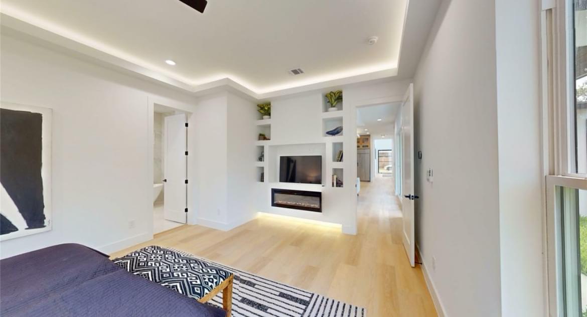 Bedroom with recessed shelf wall and built-in fireplace remodel