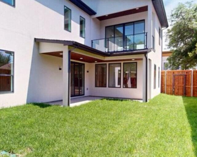 Rear view of villa with clean landscaping and new exterior paint